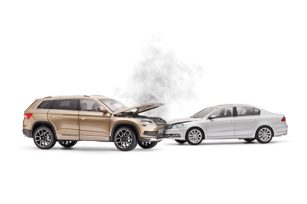 Studio shot and recreation of a head-one collision between an SUV and car. 