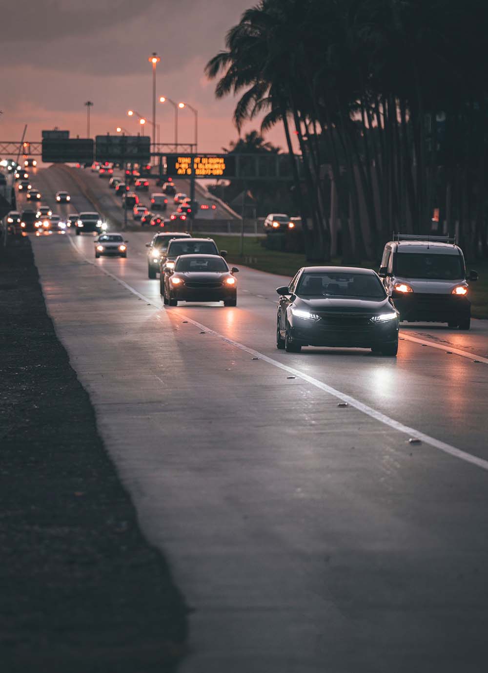 Cars driving at night along busy highway in Miami beach Florida