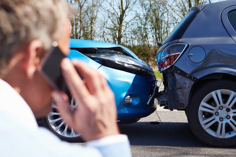 man on phone calling police after atlanta car accident